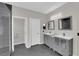 Bathroom featuring dual sink vanity, tile floors, and frameless glass shower at 11244 Gammila Dr, Las Vegas, NV 89141
