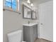 Well-lit bathroom features modern fixtures, a gray vanity, and ample natural light at 11244 Gammila Dr, Las Vegas, NV 89141