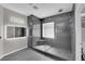 Bathroom featuring tiled walk-in shower with frameless glass enclosure and dual vanity at 11244 Gammila Dr, Las Vegas, NV 89141