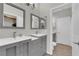 Bathroom featuring double sinks with gray cabinets and modern fixtures, providing a functional layout at 11244 Gammila Dr, Las Vegas, NV 89141