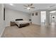 Spacious bedroom with tile floors, neutral walls, ceiling fan and walk-in closet at 11244 Gammila Dr, Las Vegas, NV 89141