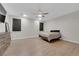 Bedroom featuring wood-look tile flooring, ceiling fan and ample natural light at 11244 Gammila Dr, Las Vegas, NV 89141