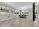 Bright dining room with tile flooring, large windows, and a modern dining set perfect for Gathering meals at 11244 Gammila Dr, Las Vegas, NV 89141