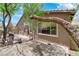Home exterior with the BBQ and outdoor seating on the patio plus view of stucco and desert landscaping at 11244 Gammila Dr, Las Vegas, NV 89141