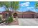 Inviting single-story home with a tiled roof, well-kept landscaping, and a two-car garage at 11244 Gammila Dr, Las Vegas, NV 89141