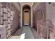 Inviting front entrance with a decorative metal gate and an arched doorway at 11244 Gammila Dr, Las Vegas, NV 89141