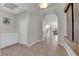 Hallway featuring a tiled floor, archway, and view into a naturally lit living room at 11244 Gammila Dr, Las Vegas, NV 89141