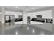 Modern kitchen boasting white cabinets, granite countertops, stainless steel appliances, and a stylish mosaic backsplash at 11244 Gammila Dr, Las Vegas, NV 89141