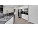 Well-lit kitchen featuring granite countertops, stainless steel appliances, and white cabinets at 11244 Gammila Dr, Las Vegas, NV 89141