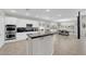 Open-concept kitchen boasts stainless appliances and granite countertops with seamless flow to dining area at 11244 Gammila Dr, Las Vegas, NV 89141