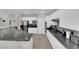 Bright kitchen featuring white cabinetry, granite countertops, stainless steel appliances, and tile flooring at 11244 Gammila Dr, Las Vegas, NV 89141