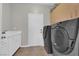 Functional laundry room with sleek washer and dryer set, sink, and storage cabinets at 11244 Gammila Dr, Las Vegas, NV 89141