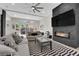 Inviting living room featuring a modern fireplace, plush seating, a striped rug, and large sliding doors for natural light at 11244 Gammila Dr, Las Vegas, NV 89141
