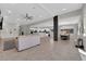 Bright, open-concept area seamlessly connecting the kitchen, living, and dining spaces, featuring tile floors throughout at 11244 Gammila Dr, Las Vegas, NV 89141