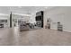 Spacious living room with a stone fireplace, mounted TV, and lots of natural light and tile flooring at 11244 Gammila Dr, Las Vegas, NV 89141