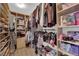 Walk-in closet with custom shelving and ample storage space for clothing and shoes at 11244 Gammila Dr, Las Vegas, NV 89141