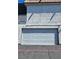 Garage door on a two-story building with a stucco finish at 1128 Willow Tree Dr # C, Las Vegas, NV 89128