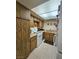 The kitchen has tile floors, wood cabinets, and appliances at 1128 Willow Tree Dr # C, Las Vegas, NV 89128