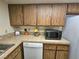 Kitchen counter with tile backsplash and wooden cabinets at 1128 Willow Tree Dr # C, Las Vegas, NV 89128