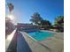 Inviting community pool with plenty of seating surrounded by lush landscaping at 1128 Willow Tree Dr # C, Las Vegas, NV 89128
