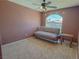 Bedroom featuring neutral carpet, a window, a ceiling fan, and a futon for seating at 1564 Silver Knoll Ave, Las Vegas, NV 89123