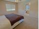 Cozy bedroom features neutral carpet, a king size bed, and an ensuite bathroom at 1564 Silver Knoll Ave, Las Vegas, NV 89123