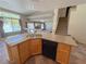 Kitchen area with stone countertops, a dual sink, black appliances, and access to the staircase and other rooms at 1564 Silver Knoll Ave, Las Vegas, NV 89123