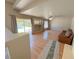 Open living room with hardwood floors, a leather couch and lots of natural light with access to the backyard at 1564 Silver Knoll Ave, Las Vegas, NV 89123