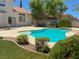 Gorgeous pool area with lush landscaping, perfect for relaxing and enjoying the outdoors at 1564 Silver Knoll Ave, Las Vegas, NV 89123
