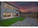 Expansive backyard featuring synthetic grass, pavers, a covered patio, and mountain views at 180 Native Stone St, Las Vegas, NV 89138