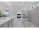 Beautiful bathroom with a glass shower, double vanity, and bedroom view at 180 Native Stone St, Las Vegas, NV 89138