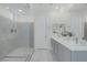 Bright bathroom features a glass-enclosed shower and dual sink vanity at 180 Native Stone St, Las Vegas, NV 89138