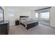 Spacious bedroom with large windows, dark wood furniture, and a private balcony offering serene outdoor access at 180 Native Stone St, Las Vegas, NV 89138