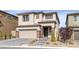 Charming two-story home with a brick-accented garage and a beautifully landscaped front yard at 180 Native Stone St, Las Vegas, NV 89138
