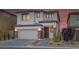 Charming two-story home with a brick-accented garage and a beautifully landscaped front yard at 180 Native Stone St, Las Vegas, NV 89138