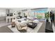 Spacious living room features an open floor plan, modern decor, and large sliding glass doors to the backyard at 180 Native Stone St, Las Vegas, NV 89138