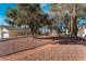 A sprawling backyard with mature shade trees and a walking path at 2086 Angel Falls Dr, Henderson, NV 89074