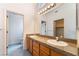 Bright bathroom features a double sink vanity with a granite countertop and modern lighting at 2086 Angel Falls Dr, Henderson, NV 89074