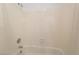 White tiled bathroom with a shower head, faucet and white tub at 2086 Angel Falls Dr, Henderson, NV 89074