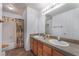 Bathroom featuring dual sinks, and an updated tile floor that complements the neutral decor at 2086 Angel Falls Dr, Henderson, NV 89074