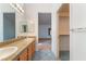 Bathroom with double sinks, granite countertop, large mirror, and access to walk-in closet at 2086 Angel Falls Dr, Henderson, NV 89074