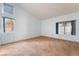 Bright bedroom featuring multiple windows, carpet, and neutral paint at 2086 Angel Falls Dr, Henderson, NV 89074