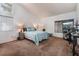 Spacious bedroom with cozy carpet, natural light, and en-suite bathroom access at 2086 Angel Falls Dr, Henderson, NV 89074