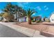 Charming single-story home featuring a well-kept yard with gravel landscaping and a palm tree at 2086 Angel Falls Dr, Henderson, NV 89074