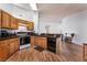 Well-lit kitchen with wood cabinets, modern appliances, and laminate floors at 2086 Angel Falls Dr, Henderson, NV 89074