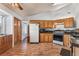 Charming kitchen featuring wood cabinets, modern appliances, and breakfast bar at 2086 Angel Falls Dr, Henderson, NV 89074