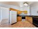 Well-lit kitchen featuring laminate floors and functional appliances at 2086 Angel Falls Dr, Henderson, NV 89074