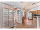 Bright kitchen view to glass-enclosed sunroom with wood floors at 2086 Angel Falls Dr, Henderson, NV 89074