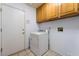 Laundry room with overhead cabinets and tiled floor at 2086 Angel Falls Dr, Henderson, NV 89074