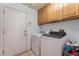 The laundry room has wood cabinets and washer-dryer hookups at 2086 Angel Falls Dr, Henderson, NV 89074